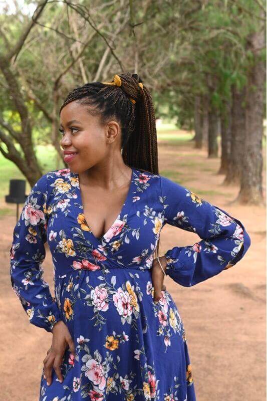 Navy blue floral maternity and nursing dress with foldover bodice and slit-detailed long sleeves