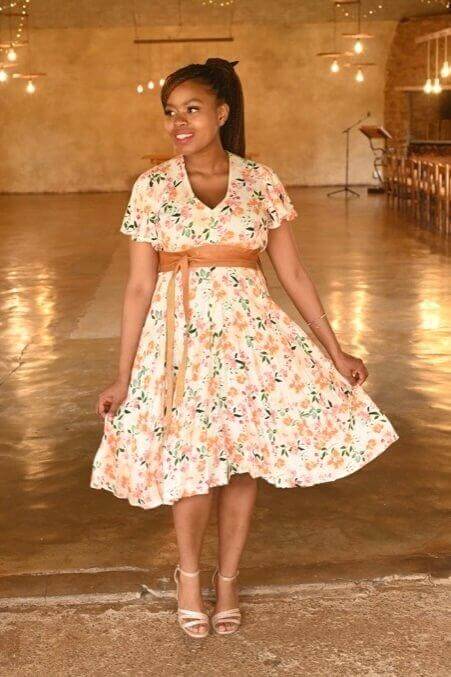 White, pink, and orange floral maternity and nursing dress with button-up front and frilly sleeves