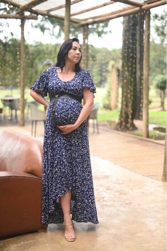 Navy and white floral maternity and nursing dress with button-up front, frilly sleeves, and hi-low silhouette