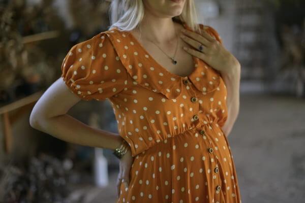 Mustard and white polka dot maternity and nursing dress with Peter Pan collar and hi-low hemline