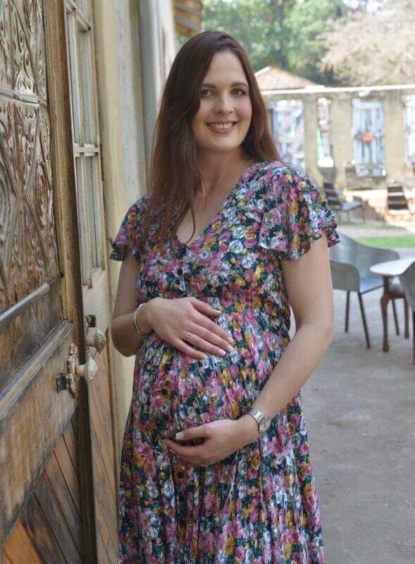 Vintage colorful floral maternity and nursing dress with button-up front, frilly sleeves, and hi-low silhouette