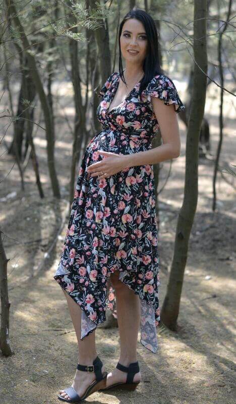 Black floral maternity and nursing dress with fold-over bodice, frilly sleeves, and pointy skirt