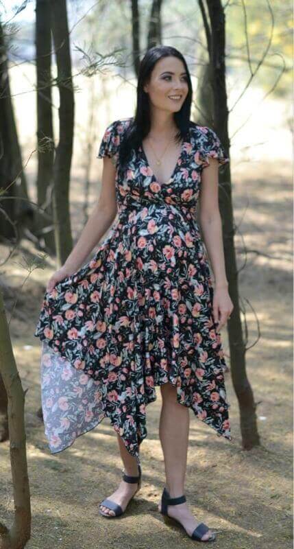 Black floral maternity and nursing dress with fold-over bodice, frilly sleeves, and pointy skirt