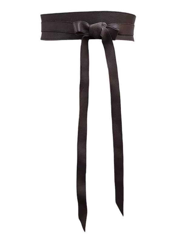 Woman wearing a self-adjustable leather waist belt over a floral maternity dress