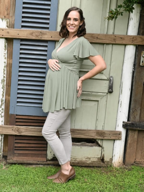 Model wearing a sage maternity and breastfeeding top with frill sleeves