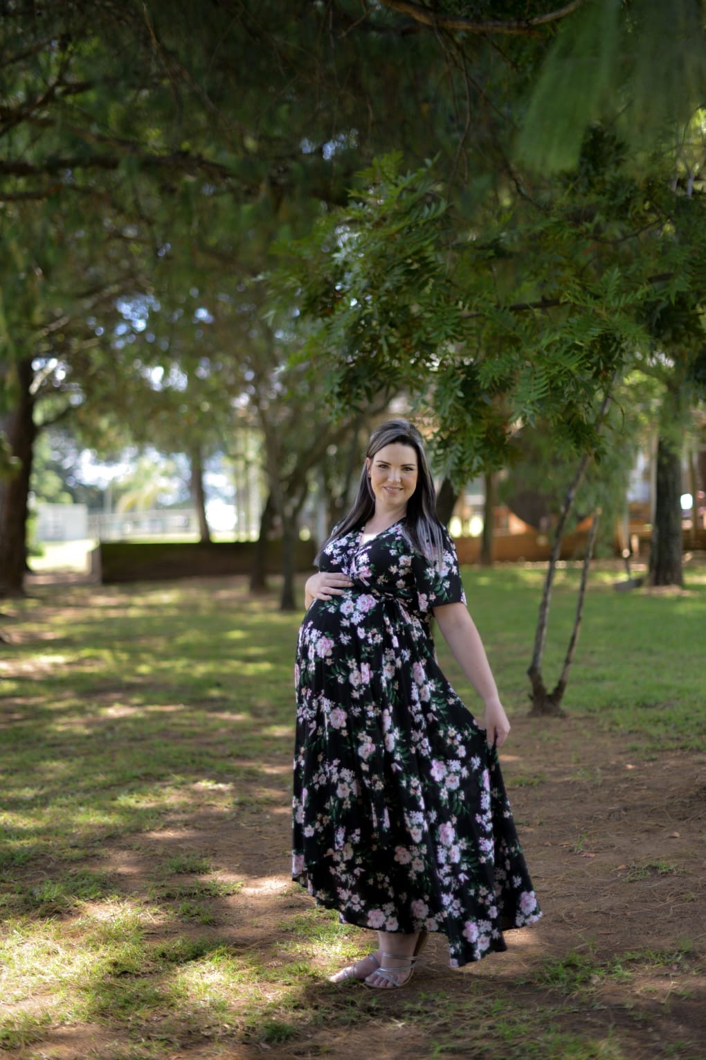 Black floral maternity wrap dress with ruffle sleeves worn outdoors
