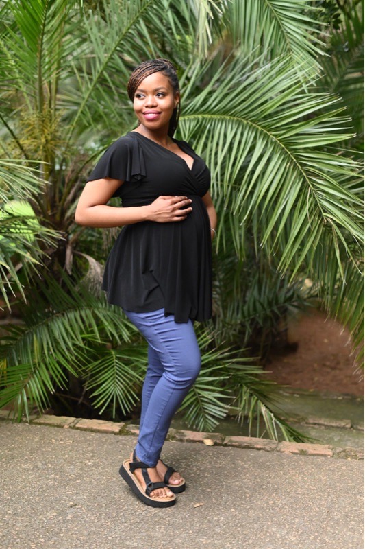 Model wearing a black maternity and breastfeeding top with frill sleeves