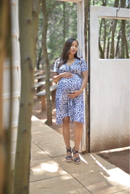 Pregnant woman wearing blue leopard print maternity nursing dress